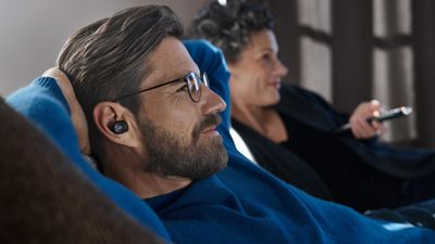 Man listening to TV using a Sennheiser TV Clear Set.
