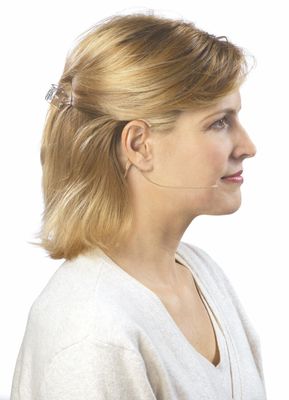 Side profile of a woman wearing a dual ear hook microphone.