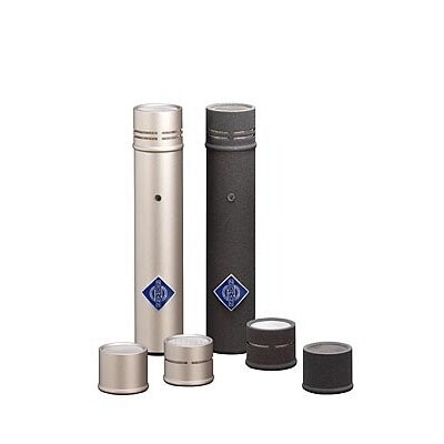Two Neuman KM180 microphone bodies in nickel and black each with a capsule fitted and more capsules below 
