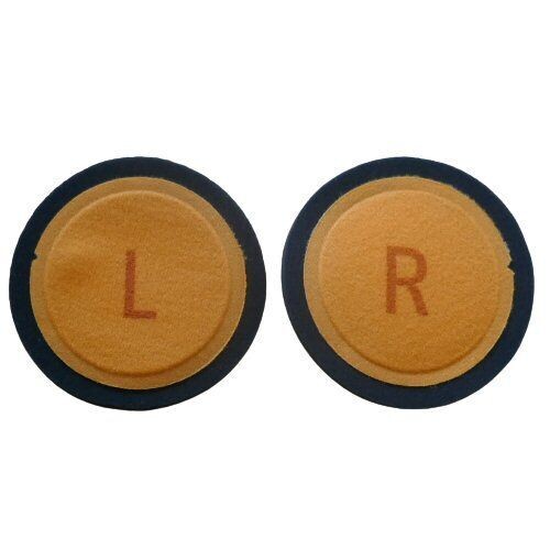 Two Neumann NDH20 orange foam ear infill cushions surrounded by a black ring and marked L and R face up on a white background