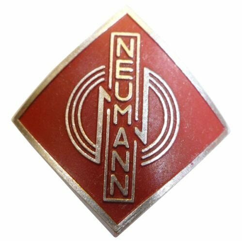 Metal alloy diamond shaped name badge Neumann 077289 with three stylised concentric rings over red on a white background