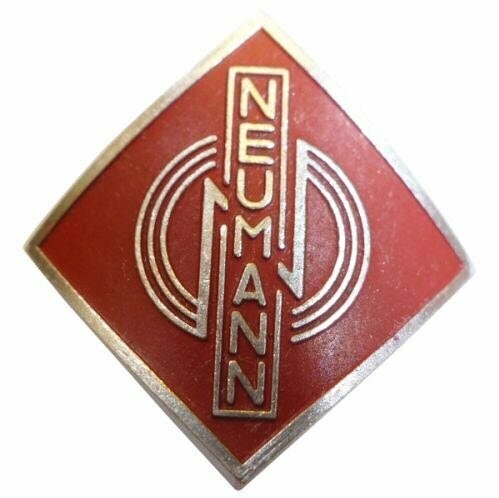Metal alloy diamond shaped name badge Neumann 077289 with three stylised concentric rings over red on a white background