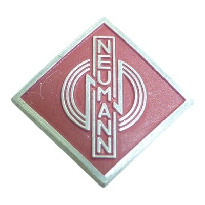 Red diamond shaped metal Logo badge in 1950s typeface Neumann with three stylized concentric circles on a white background