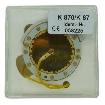 Neumann plastic box containg round capsule K870 with two yellow wires and lots of screws around a white circumference