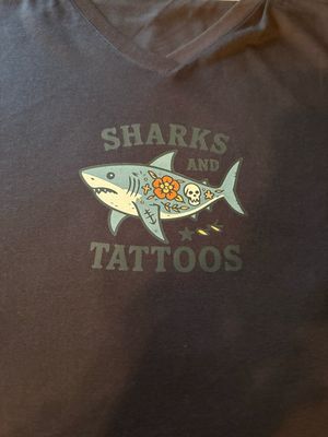 Women’s T-Shirts with an image of a Shark & Tattoos and words that say “Sharks & Tattoos”