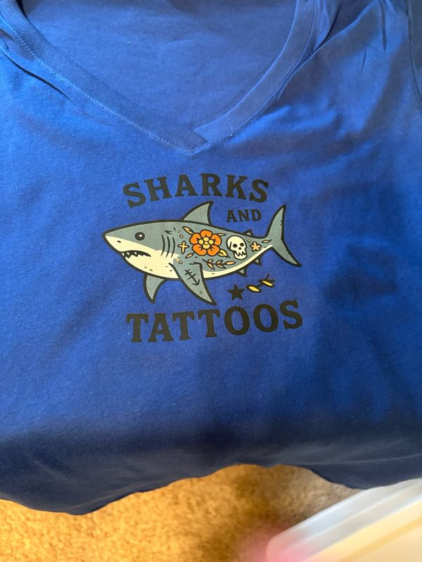 Women’s T-Shirts with an image of a Shark &amp; Tattoos and words that say “Sharks &amp; Tattoos”