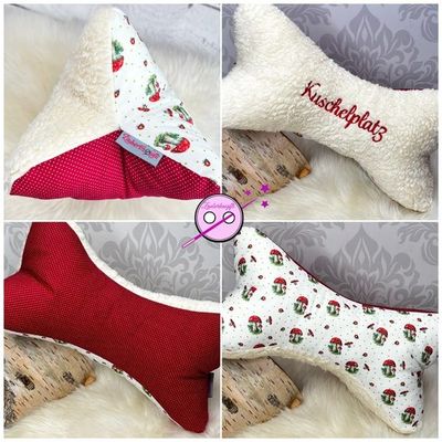 Ein Lesekissen in Form eines Knochens mit 3 verschiedenen Seiten. Eine der Seiten ist mit dem Wort Kuschelplatz bestickt. 