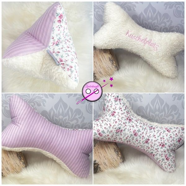 Lesekissen - Leseknochen rosa mit Streublumen. Eine Seite ist mit hellem Teddystoff bestickt mit dem Wort Kuschelplatz, eine Seite ist rosa grau gestreift und die dritte Seite hat kleine Streublumen in rosa und grün.