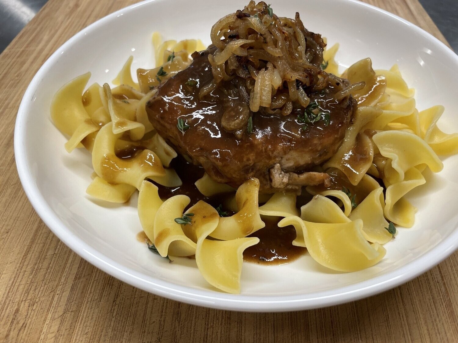 Smothered Pork Chop with Buttered Egg Noodles and Maple Roasted Carrots