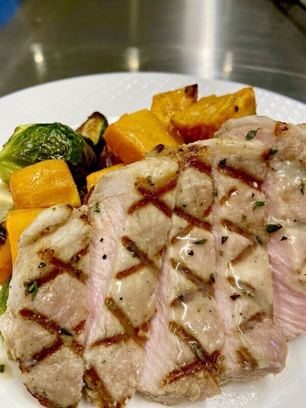 Grilled Pork Chops and Specialty Topper with Roasted Potatoes and Summer Vegetables