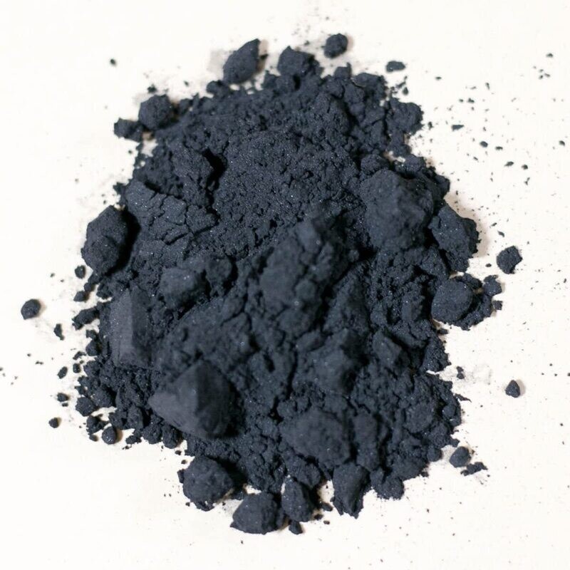 Airfloat charcoal powder, black granules on a light surface, relevant to pyrotechnics and target practice supplies.