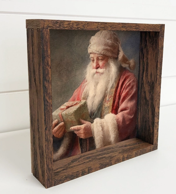 Vintage Santa Holding Gift Framed Canvas Print