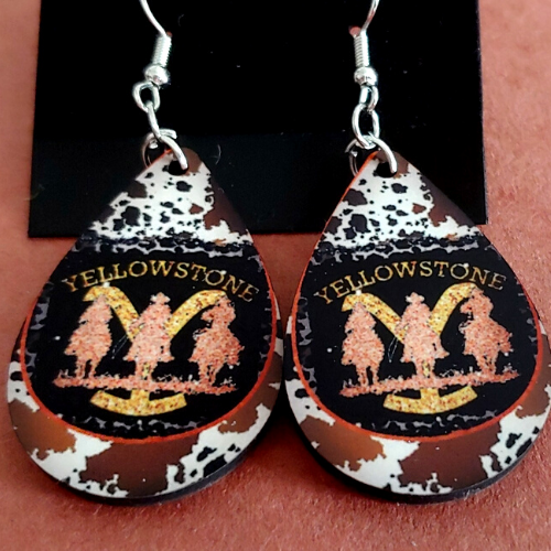 Yellowstone Earrings with cowhide design background