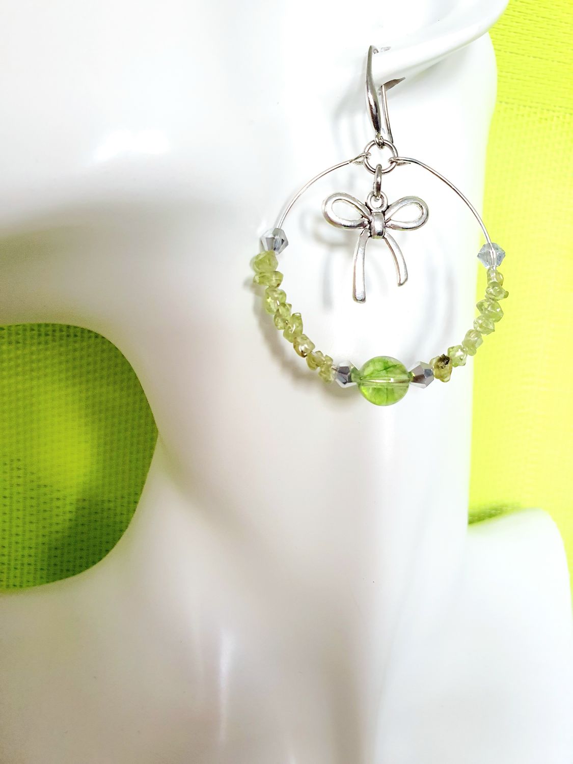 💚 Créoles en acier inoxydable. Chips et perles en véritable Olivine des Canaries. Petits nœuds papillons. Création artisanale. Modèle unique.