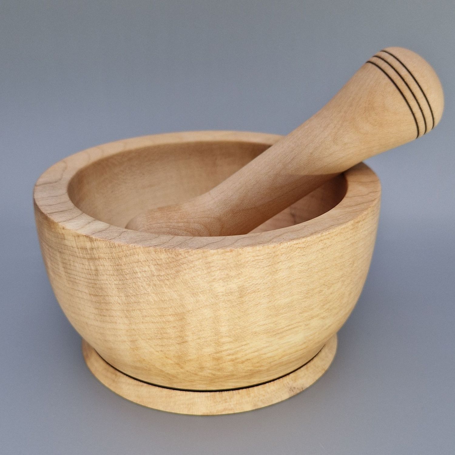 Sycamore pestle and mortar set with smooth finish and wire-burnt rings, handcrafted for grinding herbs and spices.