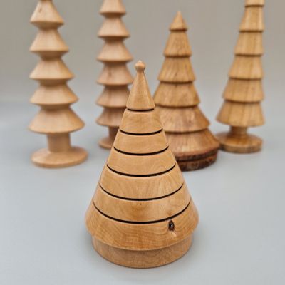 Hazel wood tree with six flared tiers and smooth base. Finished with carnauba wax to impart a soft sheen and highlight grain