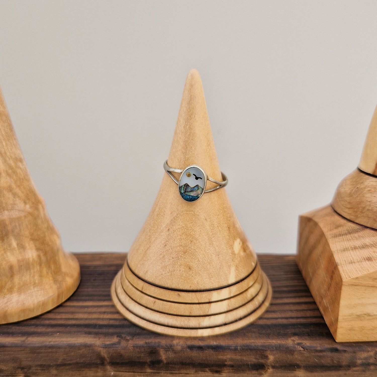 Birch wood ring holder with four burnt rings, finished with a soft sheen. 