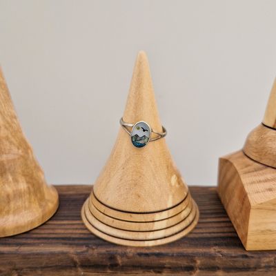 Birch wood ring holder with four burnt rings, finished with a soft sheen. 