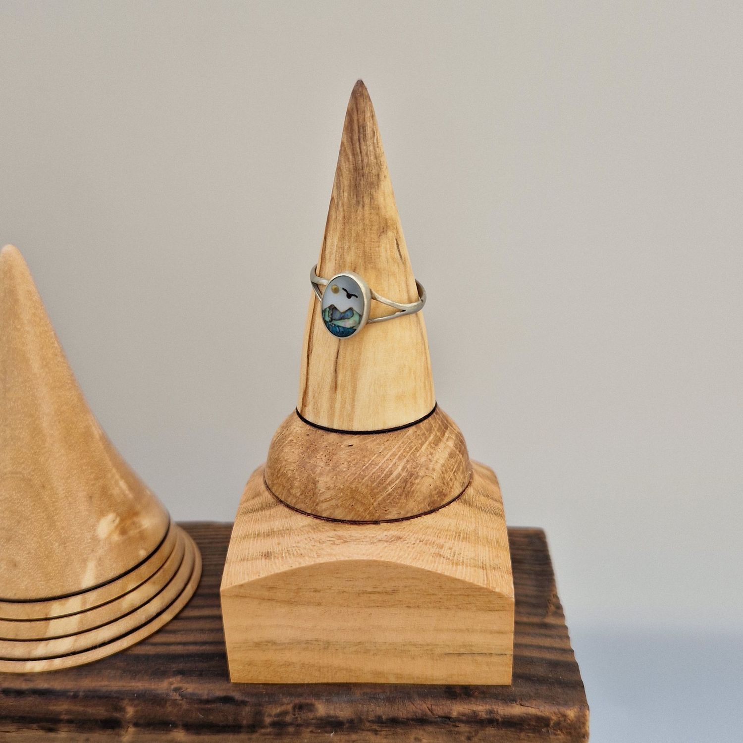 Ring holder with wire-burned rings and square base, turned from mixed native Scottish woods.