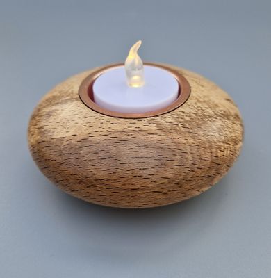  Pebble-shaped tealight holder in spalted beech with copper insert; compact and softly curved.
