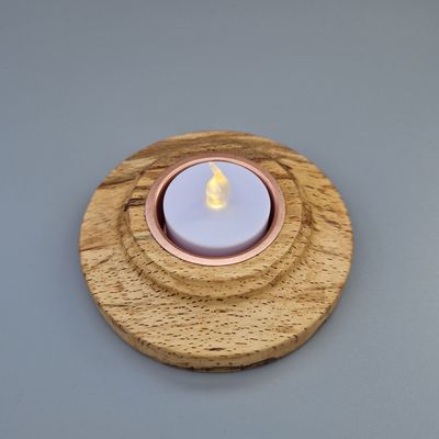 Flat tealight holder in spalted beech with copper insert; low profile and warm grain.