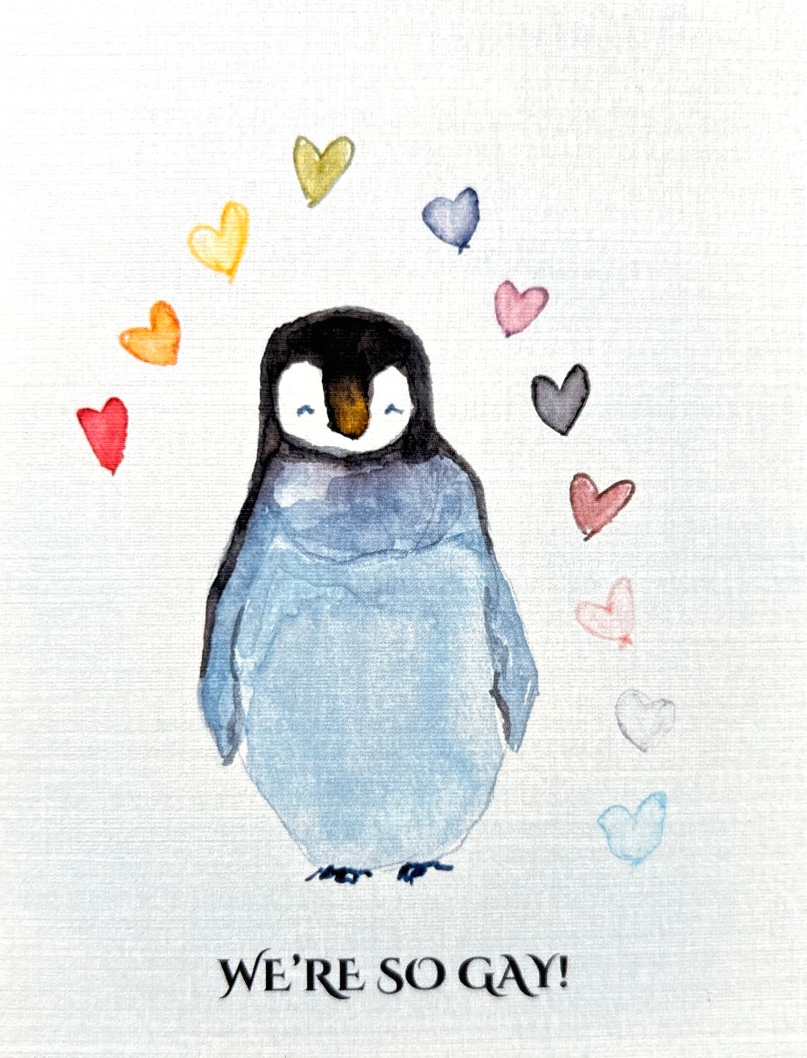 Queer Pride Hand Painted Watercolor Sticker Featuring a Penguin and Rainbow Hearts in Blue and Rainbow Gay Pride Colors
