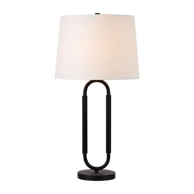 The juxtaposition of an off-white shade and sleek matte black iron frame within this table lamp design allows it to feel both elegant and utilitarian. Set within the industrial-style interior or hotel space, it will earn clients endless praise from passersby. An idyllic fit for the bedside table or living room end table, when lit, this table lamp’s warm glow brings a softness to its overall impact.