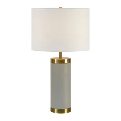 At once on-trend and timeless, this table lamp elevates the aesthetic appeal of the contemporary interior. Its soft palette of light grey and antique brushed brass base, with an off-white shade, creates an environment that is soft and welcoming. Its design offers for plethora of styling opportunities.
