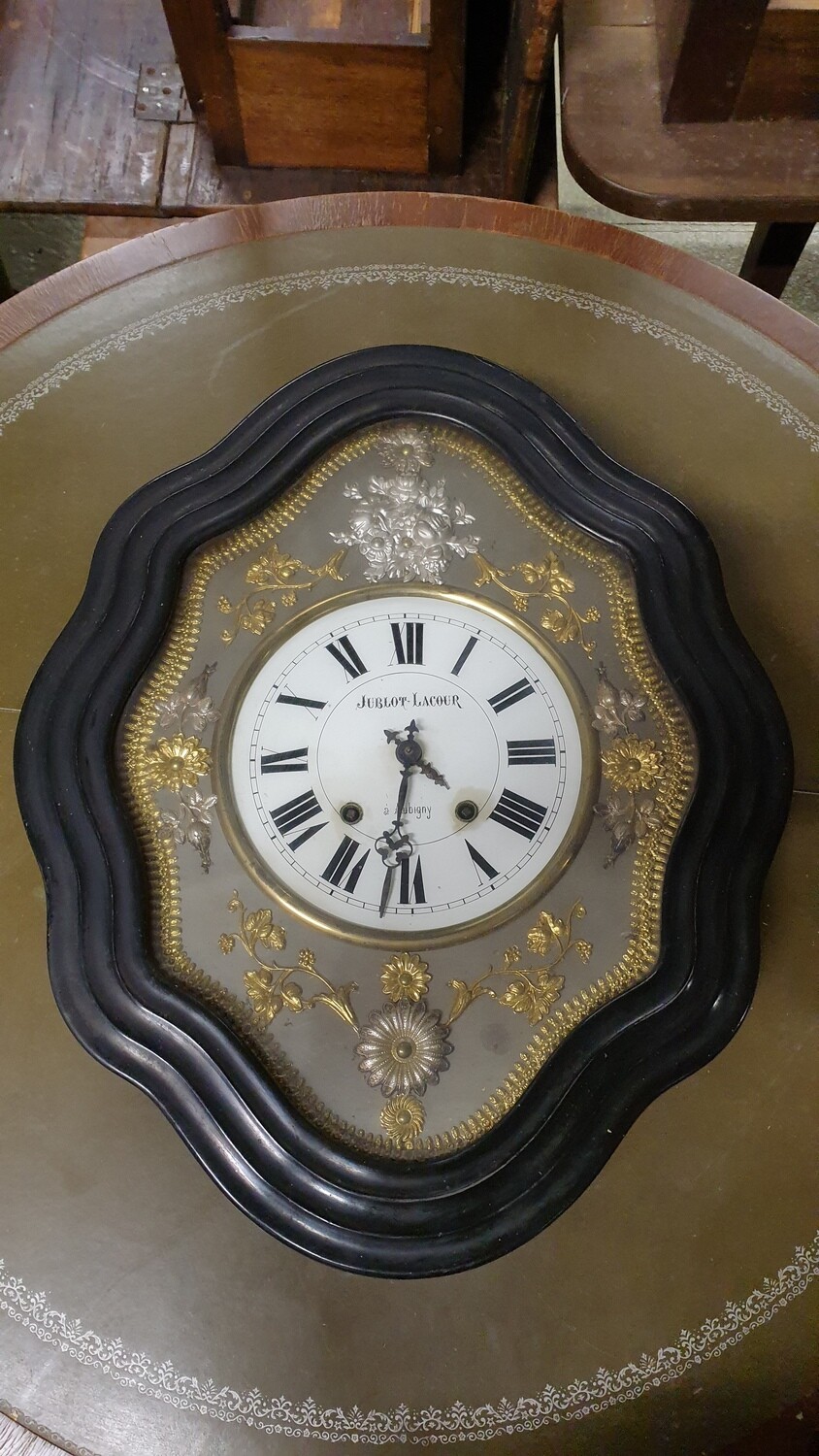 JUBLOT LACOUR à Aubigny carillon œil de bœuf à décor floral en métal repoussé or et argent. Epoque N III.