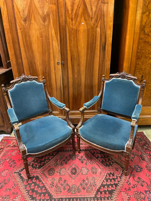 Paire de fauteuils à la reine en bois mouluré et sculpté avec garniture en velours bleu. H : 100 cm.