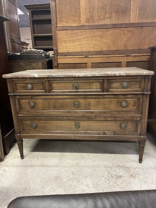 Commode de style LouisXVI, ouvrant par cinq tiroirs sur trois rangs, dessus marbre. 87x129x61.5 cm.