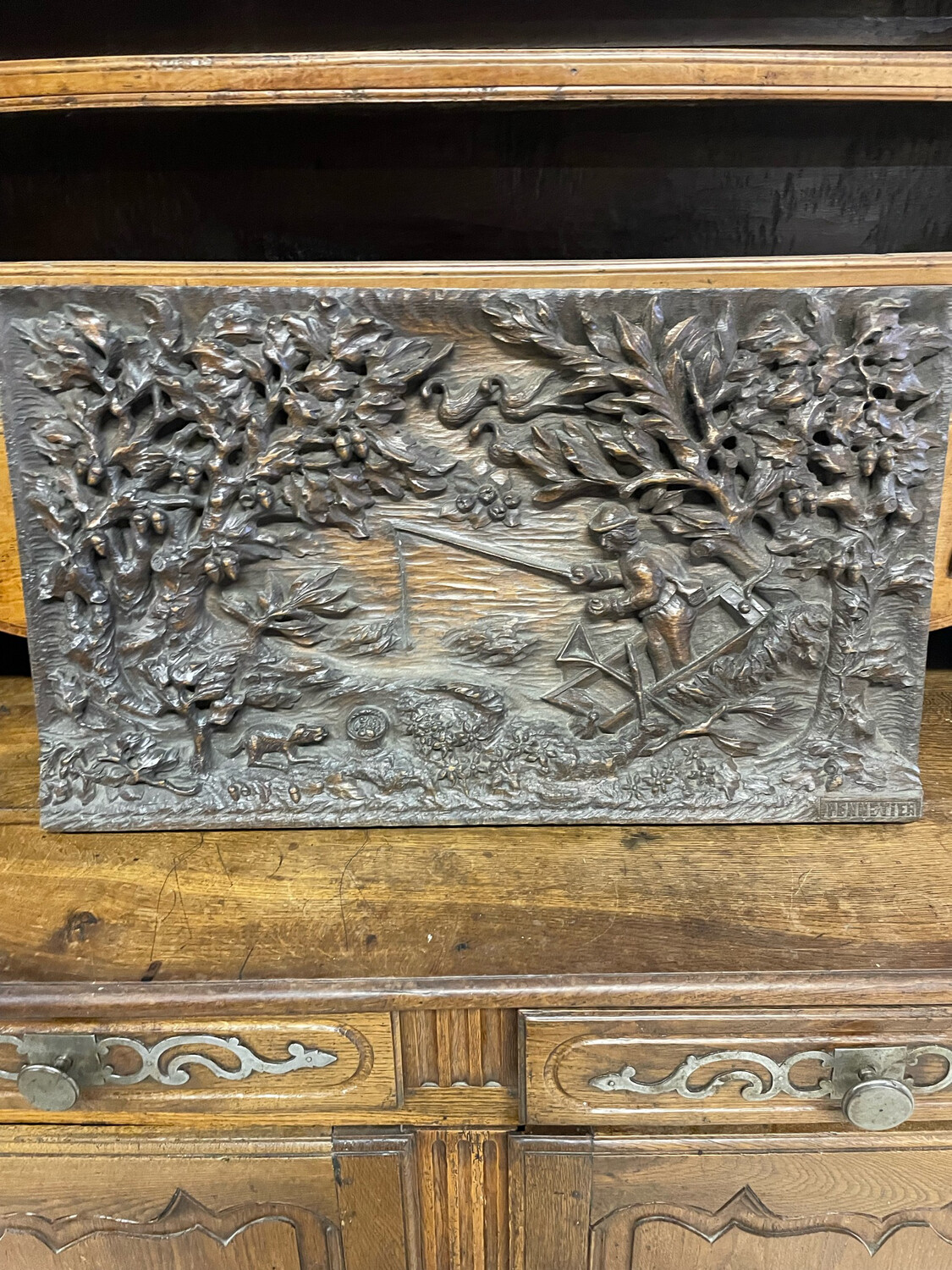 Panneau de bois sculpté représentant un pêcheur dans barque, signé PENNETIER. 43.5x75 cm