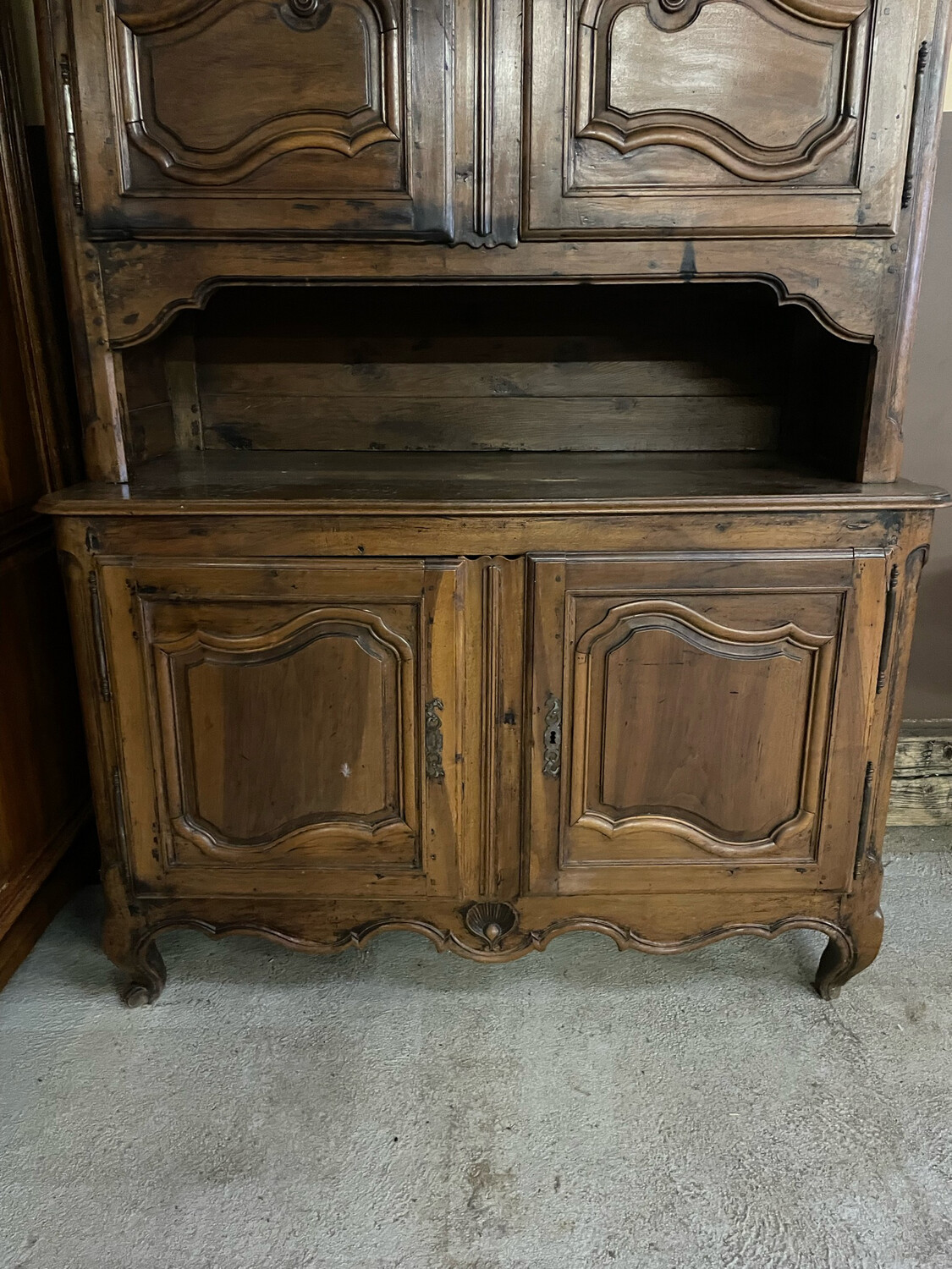 Buffet à deux corps, à niche, en noyer mouluré et sculpté. Il ouvre par quatre vantaux. Travail régional du XVIIIème siècle. H_255 cm L_151 cm P_68 cm