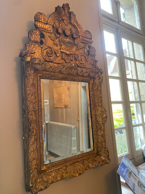Miroir en bois sculpté et doré sommé d'une corbeille fleurie. XVIII ème.
90×50 cm.