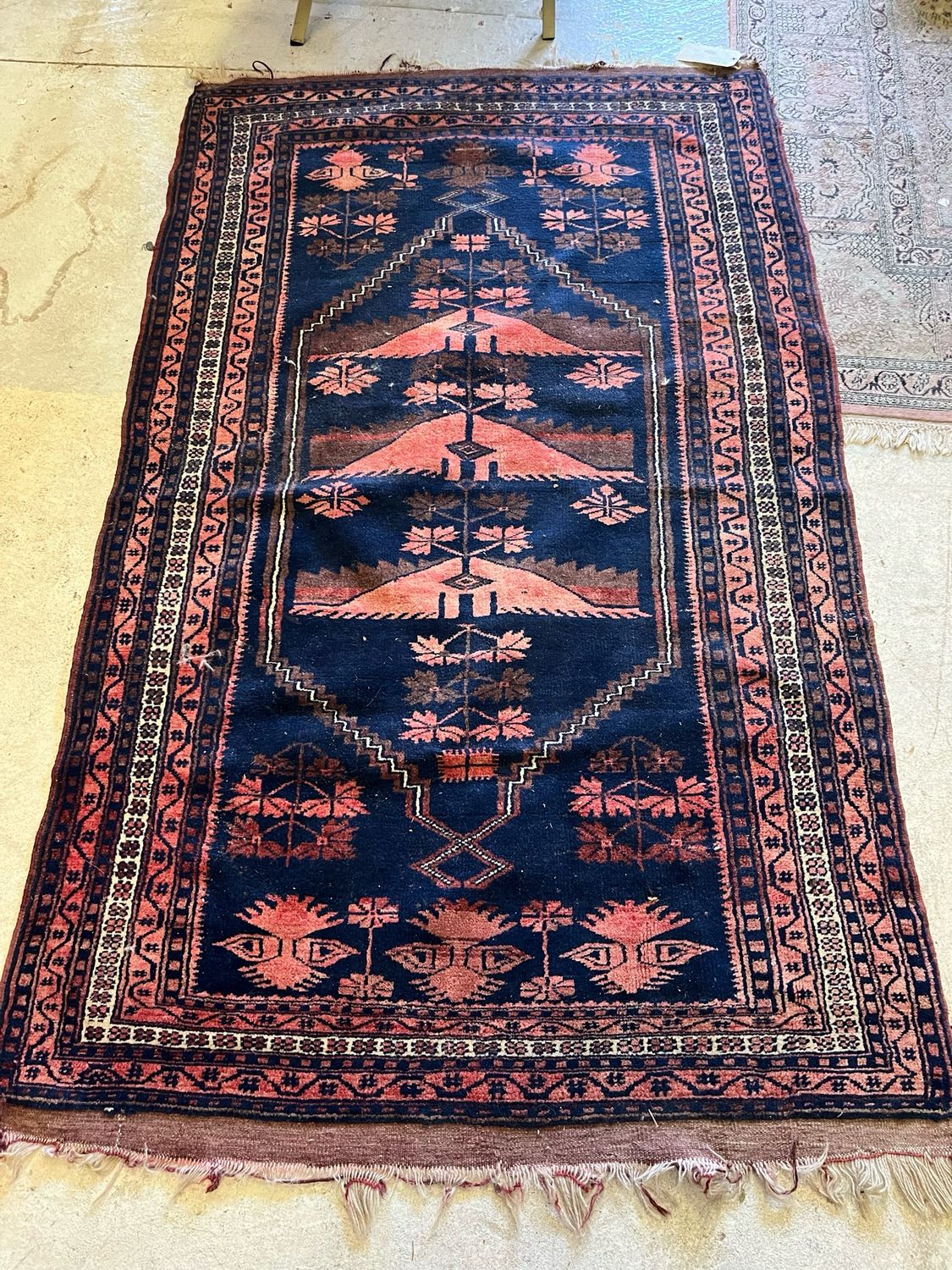 Tapis en laine à décor géométrique brique sur fond bleu - 190 x 115 cm