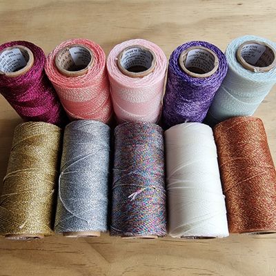 Metallic Linhasita waxed cord in 0.5mm and 1mm, sparkling in vibrant colors—ideal for adding shimmer to jewelry and macramé creations.