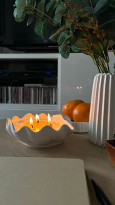 Scented candle in a shell-shaped plaster shell