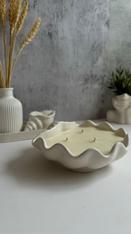 Scented candle in a shell-shaped plaster shell