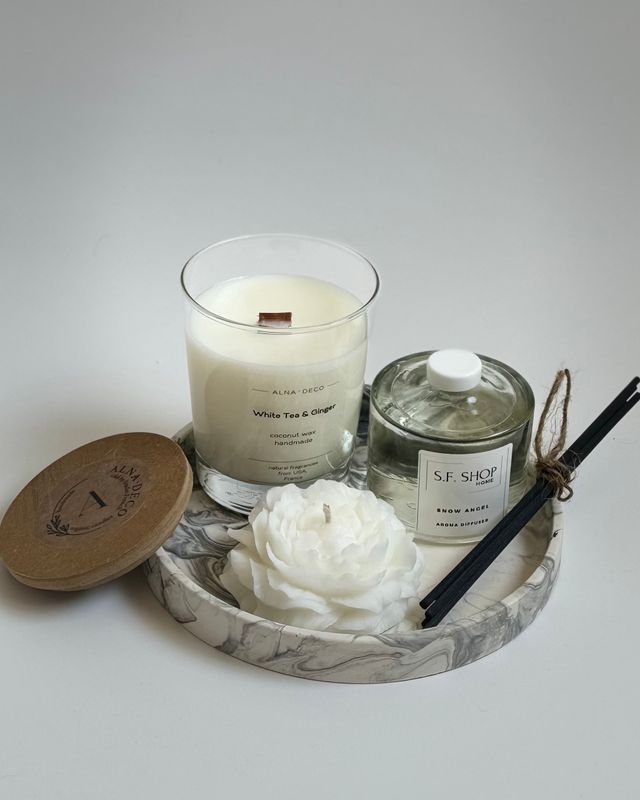 Aroma box with a candle in the shape of a peony on a round stand