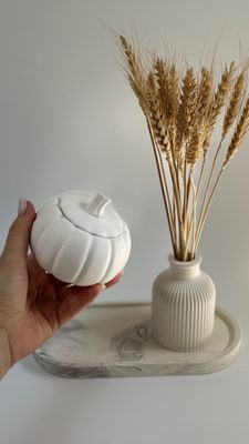 Set with pumpkin. Vase for dried flowers and candle on an oval stand