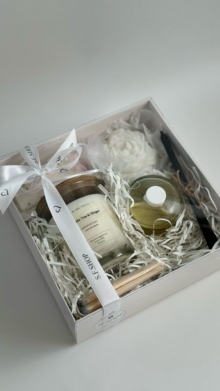 Aroma box with a candle in the shape of a peony on a round stand