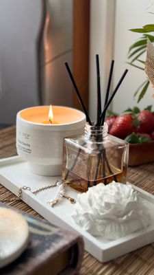 Set with decorative peony, candle and diffuser on a rectangular stand
