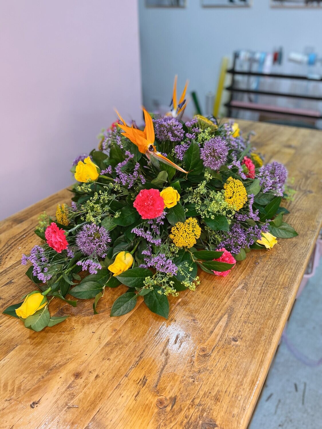 Vibrant Tropical Touch Casket Spray Funeral Flowers Tribute