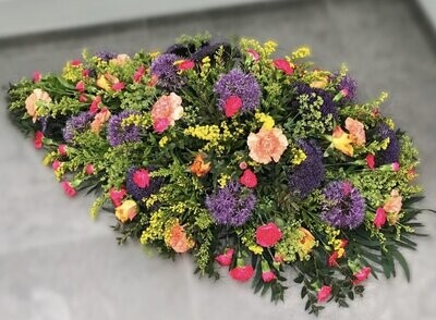 Vibrant Casket Spray Funeral Flowers Tribute