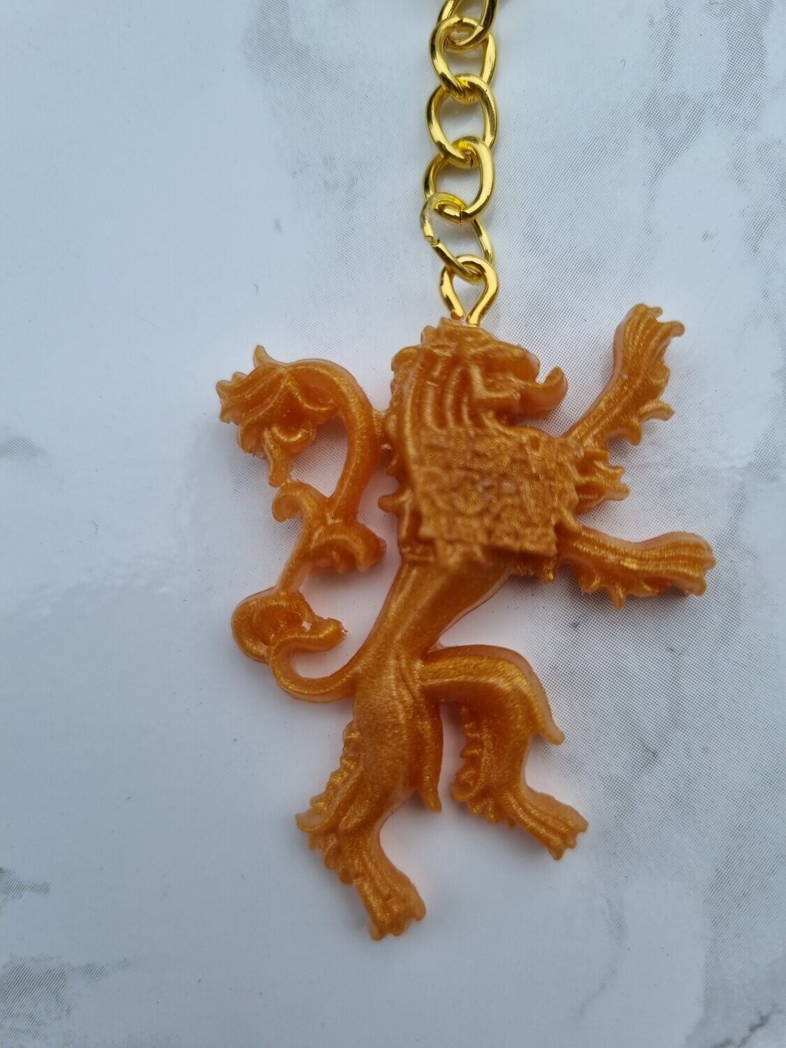 Porte clé GOT Lanister doré
