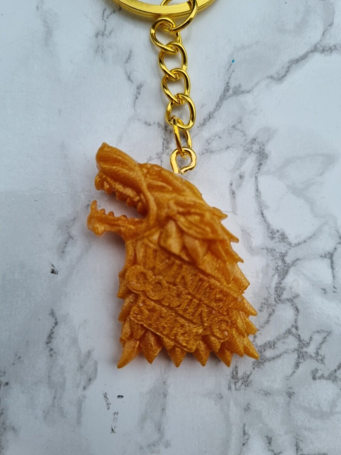 Porte clé GOT Stark doré