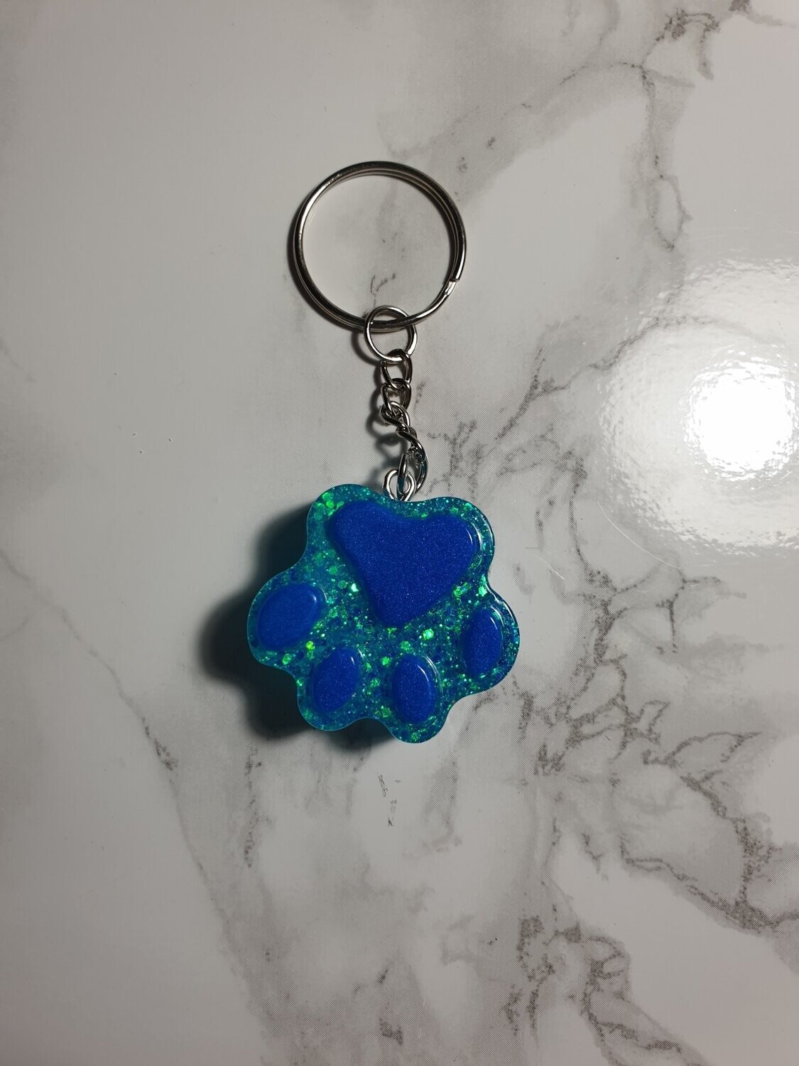 Porte de clé Patte bleue à paillettes