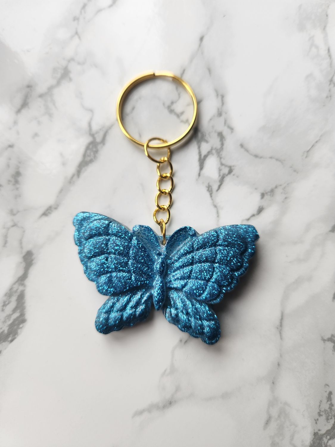 Porte clé Papillon bleu pailleté