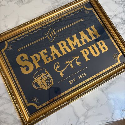 Custom framed metallic foil pub sign with gold lettering and ornate frame