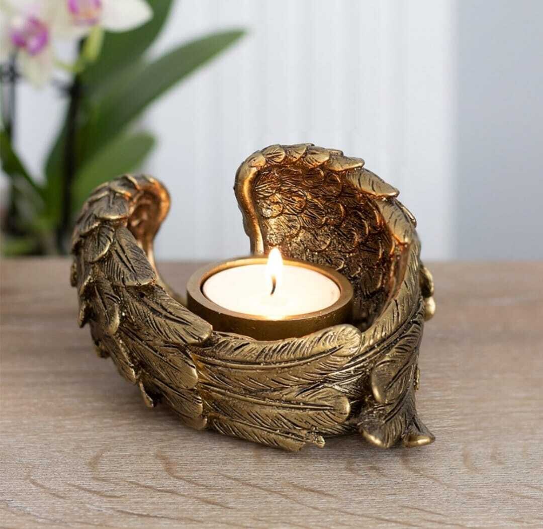 Angel wing tea light candle holder.